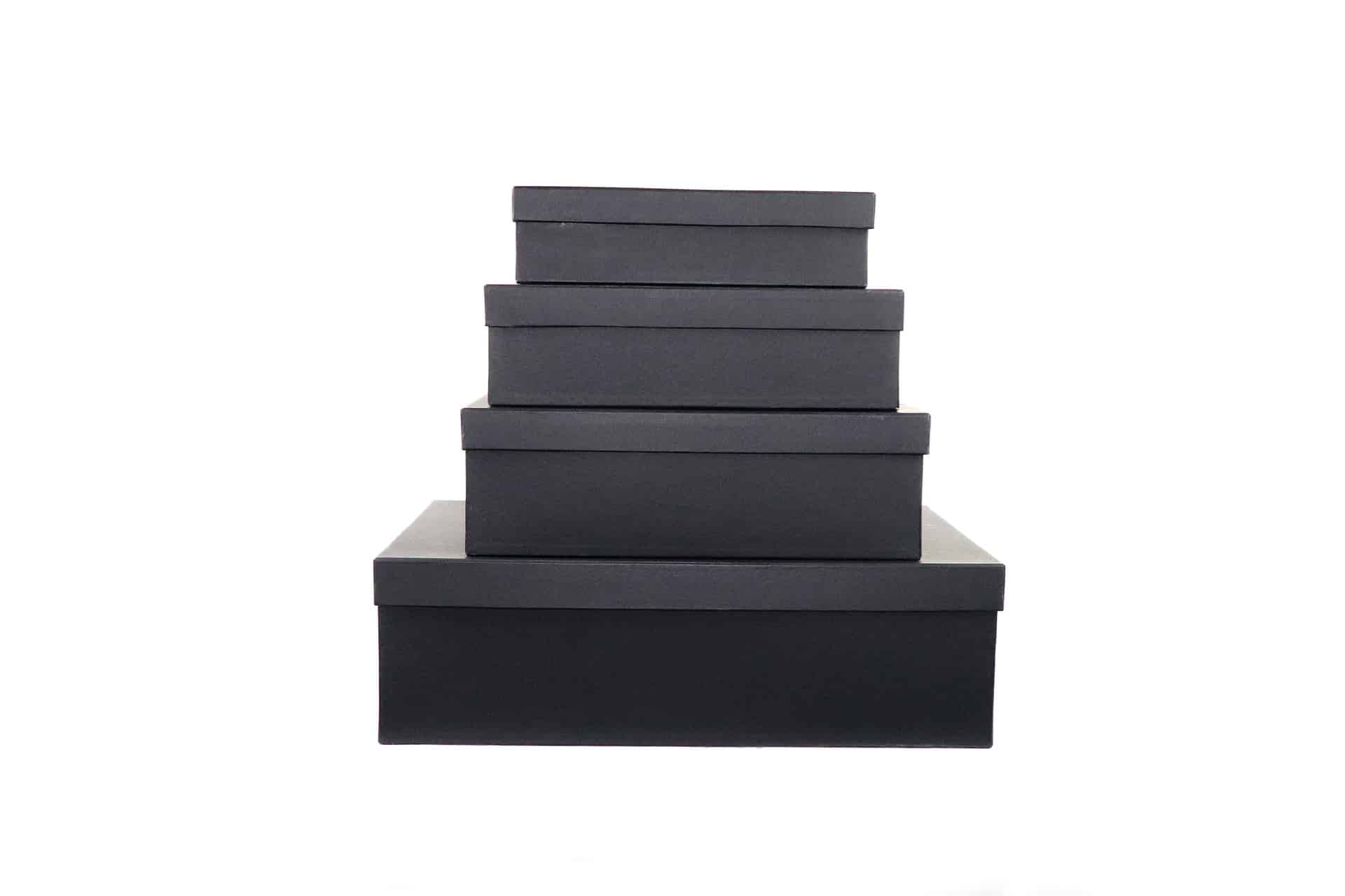 Four black boxes piled on top of one another