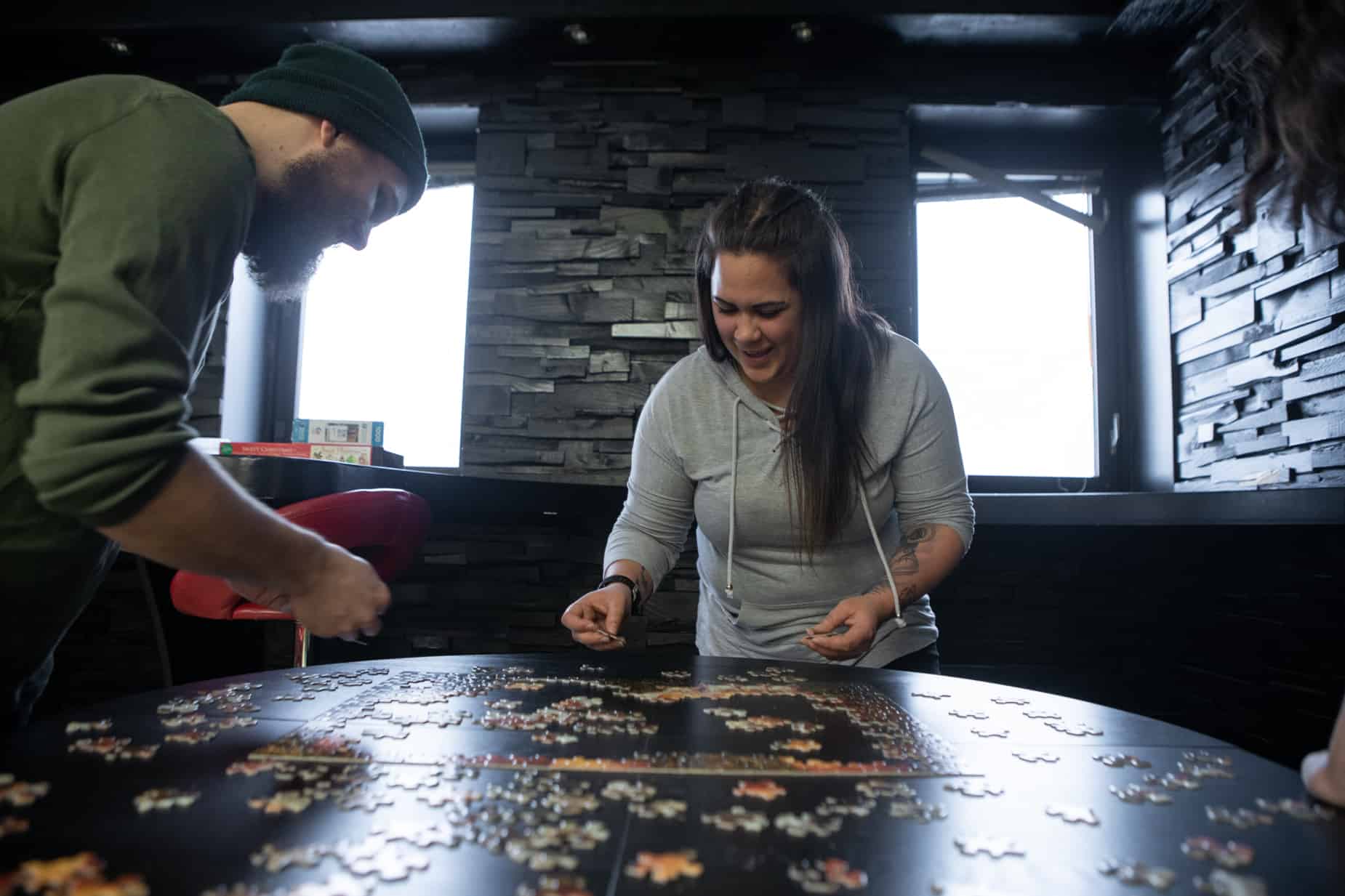 PLATO employees doing a puzzle together