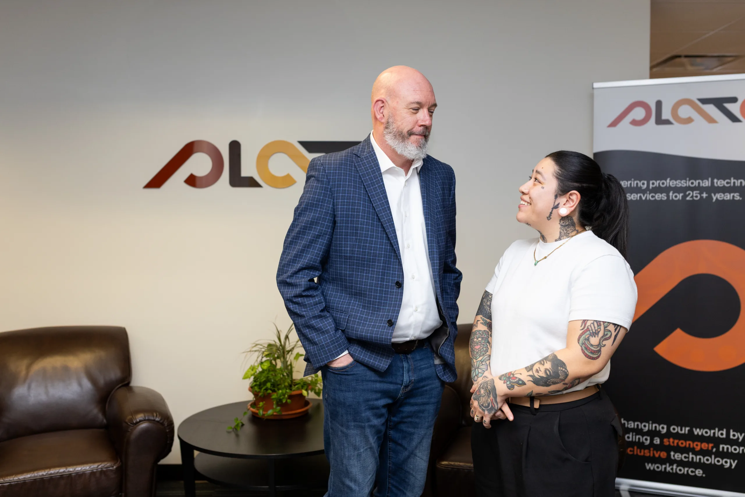 Image showing two people in conversation in an office setting.