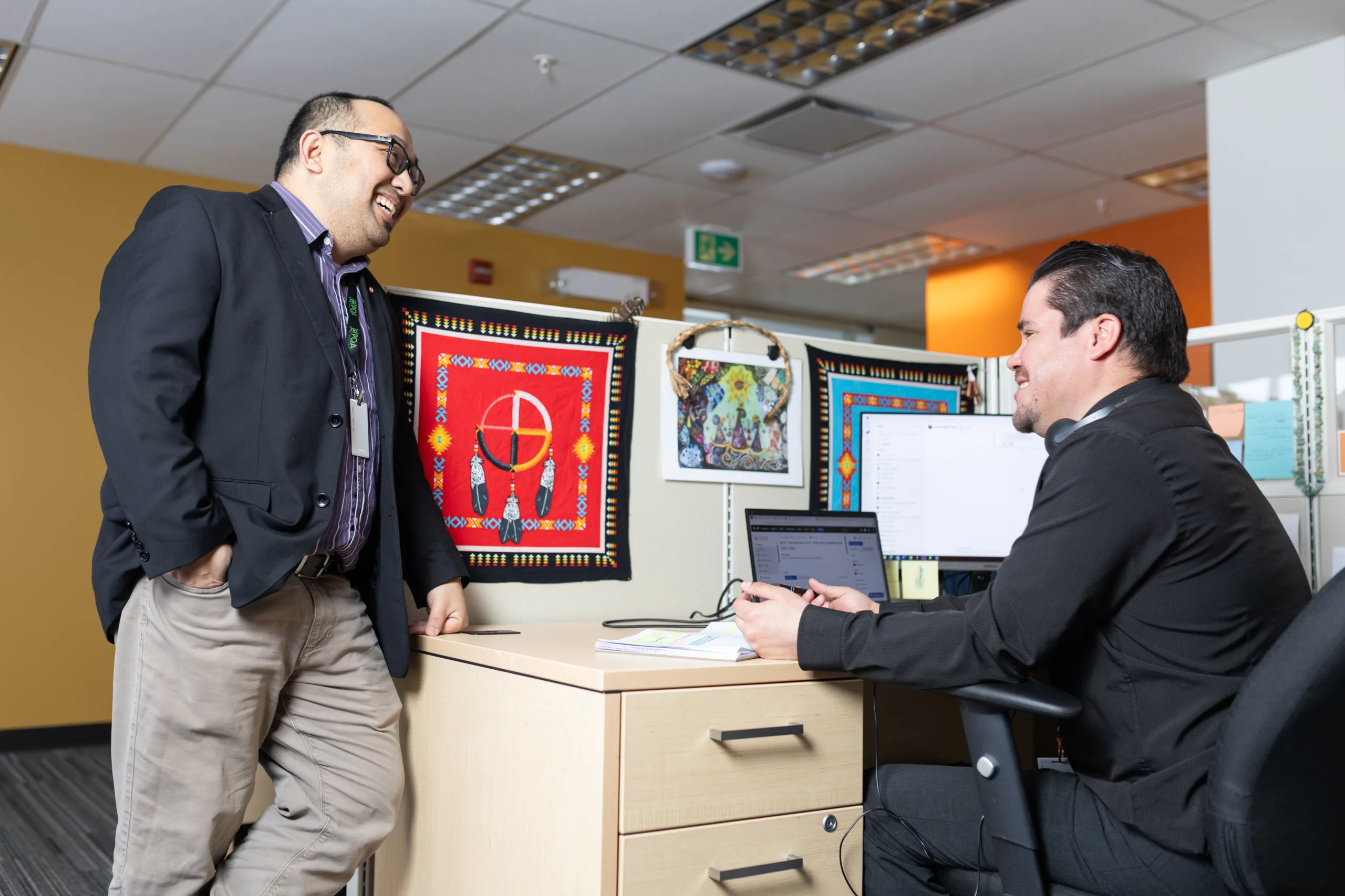 Image showing two people in conversation in an office setting.